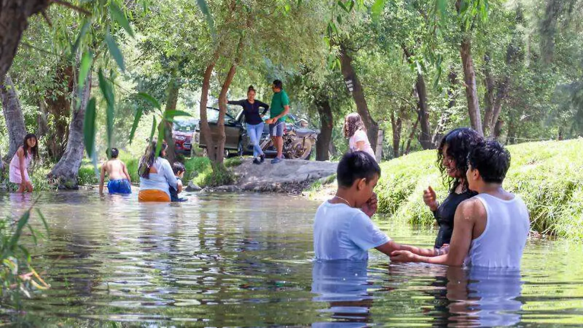 Las familias disfrutan un chapuzón en el agua clara de estas albercas naturales